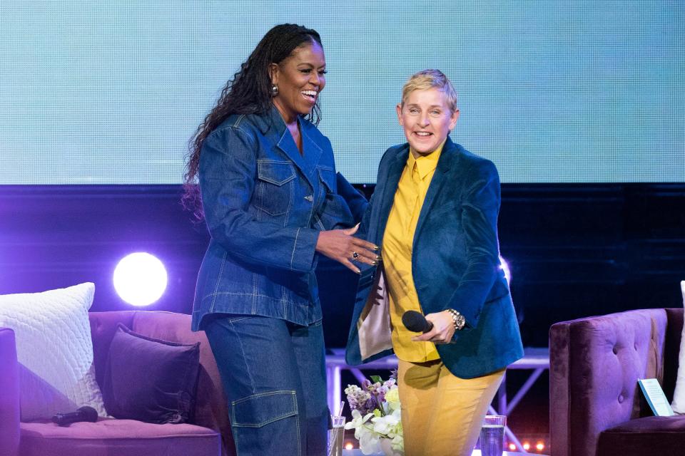 Former first lady Michelle Obama greets Ellen DeGeneres on stage as she launches her new book “The Light We Carry: Overcoming in Uncertain Times” at Warner Theater in Washington on Nov.15.