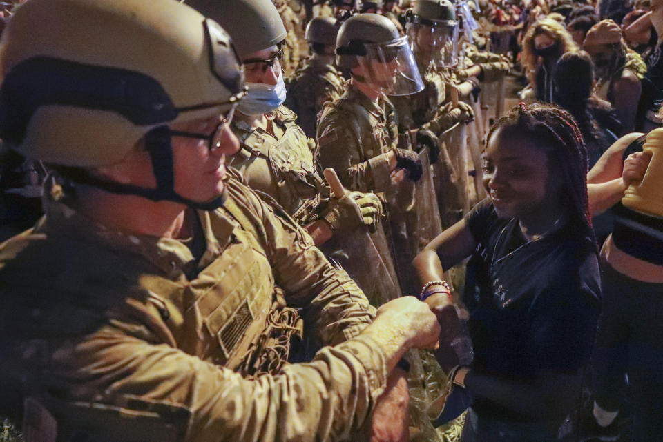 A Utah National Guard soldier fist-bumps with a demonstrator as protests over the death of George Floyd continue, Wednesday, June 3, 2020, near the White House in Washington. Floyd died after being restrained by Minneapolis police officers. Safety is the primary reason why the status of the fist bump elevated big-time in 2020. The handshake was simply a causality of the coronavirus. Once a customary greeting, it has become beyond frowned upon. (AP Photo/Alex Brandon, File)