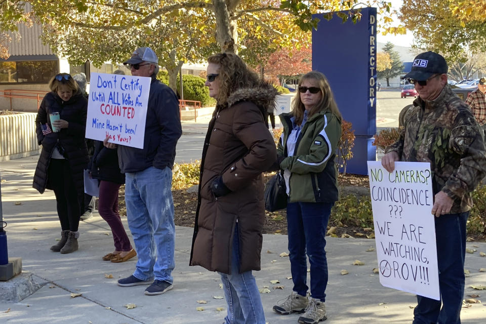 People line up outside outside the Washoe County Commission chambers to demand a hand count of ballots before commissioners were scheduled to canvass the vote in Reno, Nev., Friday, Nov. 18, 2022. (AP Photo/Scott Sonner)