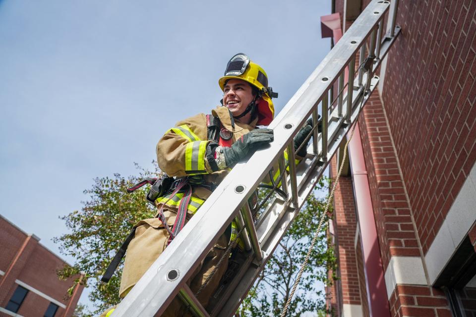 Firefighter Matt Lopez climbs a ladder at the Pflugerville Fire Department's Station 1. Lopez has been working for the department for two years after graduating in 2020 from Hendrickson High School, where he completed both the Fire and EMT academies.