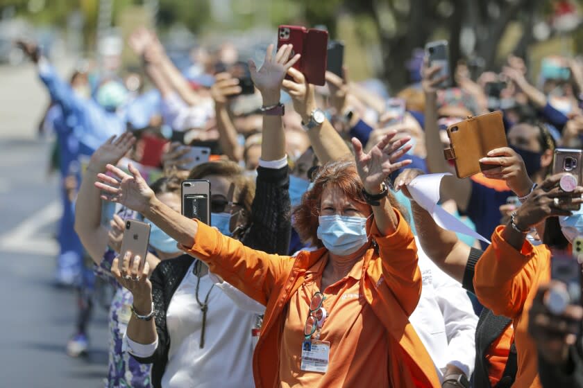 LONG BEACH, CA - MAY 13: Nora Mason and other healthcare workers rejoice Operation Thank You Long Beach parade staged by first responders in honor of Hospital Week and to salute health care workers at Dignity Health St. Mary Medical Center on Wednesday, May 13, 2020 in Long Beach, CA. (Irfan Khan / Los Angeles Times)