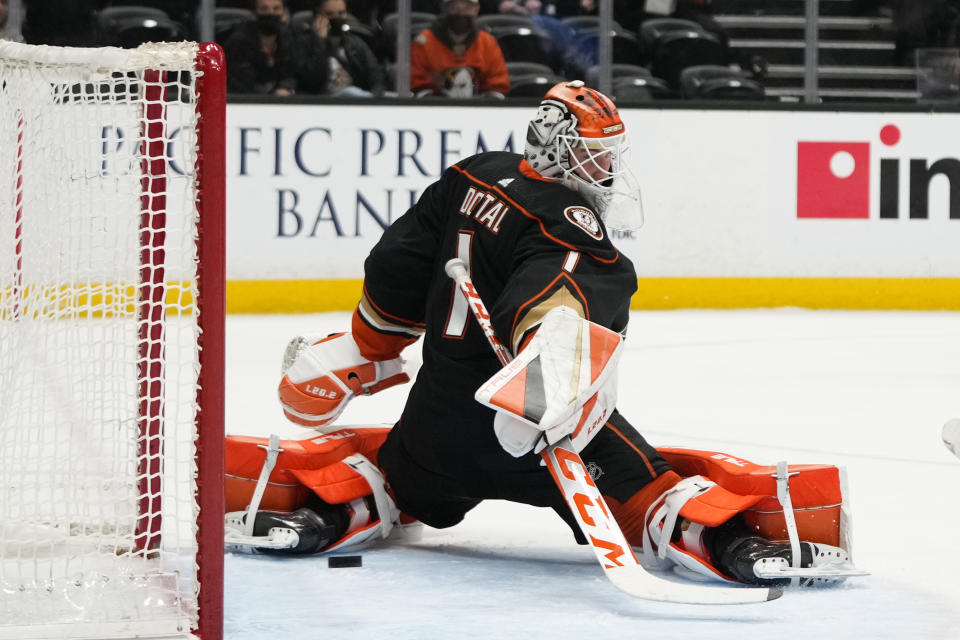 The puck hit by Columbus Blue Jackets' Cole Sillinger enters the net for a goal past Anaheim Ducks goaltender Lukas Dostal during the second period of an NHL hockey game Friday, March 17, 2023, in Anaheim, Calif. (AP Photo/Jae C. Hong)