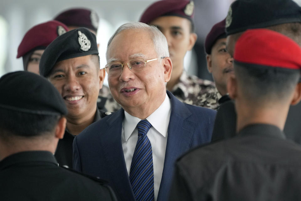 Former Malaysian Prime Minister Najib Razak arrives at the Kuala Lumpur High Court complex escorted by prison officers in Kuala Lumpur, Malaysia, Thursday, April 4, 2024. (AP Photo/Vincent Thian)