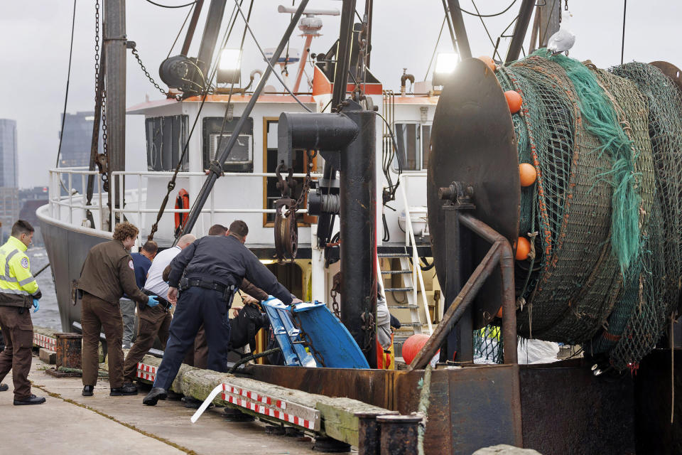 This image provided by NBC10 Boston shows first responders tending to a man on a stretcher Tuesday, Sept. 26, 2023, in Boston, who had fallen overboard from the tanker MTM Dublin in rough seas off Boston. Officials say the crew of a fishing boat recovered a man who had fallen overboard from a tanker and began CPR. The Coast Guard says a mayday from the tanker MTM Dublin went out shortly after 4:30 a.m. The man’s condition is not known. (NBC10 via AP)