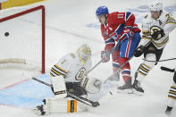 Montreal Canadiens' Brendan Gallagher (11) moves in against Boston Bruins goaltender Jeremy Swayman, left, as Bruins' Charlie McAvoy (73) defends during first-period NHL hockey game action in Montreal, Saturday, Nov. 11, 2023. (Graham Hughes/The Canadian Press via AP)