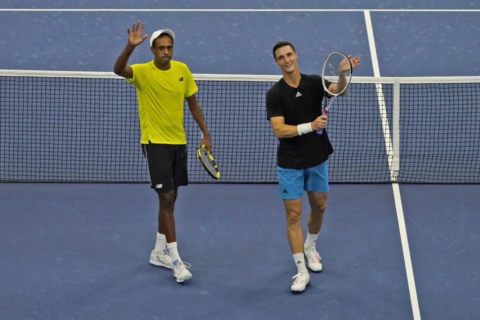 Rajeev Ram, left, of the United States, and Joe Salisbury, of Britain, celebrate after defeating Steve Johnson and Sam Querrey, both of the United States, in the men's doubles semifinals of the U.S. Open tennis tournament in New York, Thursday, Sept. 9, 2021. (AP Photo/Seth Wenig)