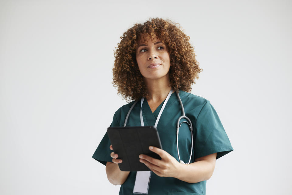 young female doctor holding an ipad