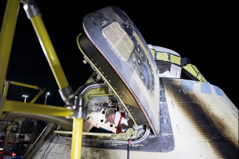 Boeing and NASA teams unload cargo from NASA's Boeing Starliner spacecraft after it landed uncrewed at White Sands Missile Range's Space Harbor, on Frida. NASA Photo by Aubrey Gemignani/UPI