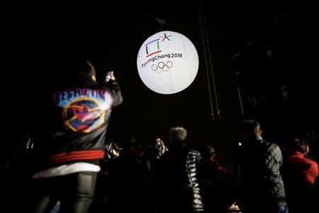 Photographers take photographs of a giant inflatable ball bearing the logo of the 2018 Pyeongchang Winter Olympics in Incheon, South Korea, November 1, 2017. REUTERS/Kim Hong-Ji/Files