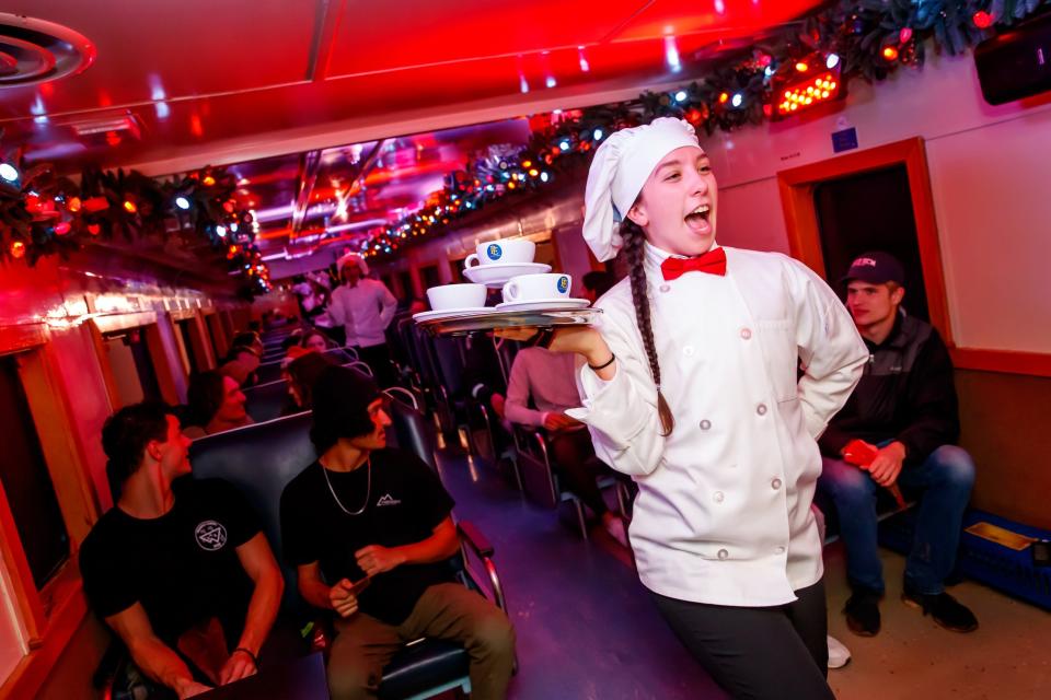Performers dressed as chefs dance and sing "Hot Chocolate" before serving refreshments to passengers on Oklahoma City's "The Polar Express Train Ride," produced by Rail Events Productions, Thursday, Nov. 10, 2022. Based on the beloved book and movie, the rides continue through Dec. 27 at the Oklahoma Railway Museum in Oklahoma City.