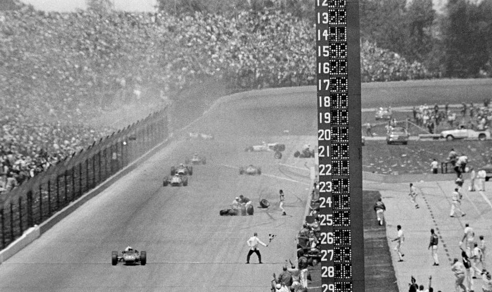 FILE - A.J. Foyt, foreground left, drives his Coyote Ford past the checkered flag after avoiding a multi-car wreck on the last lap to win the Indianapolis 500 auto race at Indianapolis Motor Speedway in Indianapolis, Ind., on May 31, 1967. (AP Photo/File)