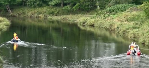 Two boats scour either side of the Annapolis River near Middleton, N.S., on Sept. 12.  (Submitted by Ian Swinamer - image credit)