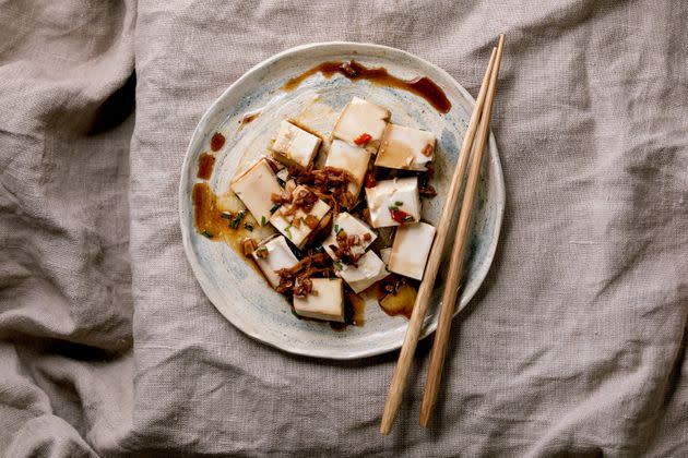 Silk tofu japanese soy cheese sliced cubes with chili ginger, chive and soy sauce. (Photo: Natasha Breen via Getty Images)