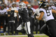 Las Vegas Raiders quarterback Jarrett Stidham (3) scrambles for a touchdown with Jacksonville Jaguars defensive tackle Jay Tufele (97) in pursuit during the first half of the NFL football exhibition Hall of Fame Game, Thursday, Aug. 4, 2022, in Canton, Ohio. (AP Photo/David Richard)