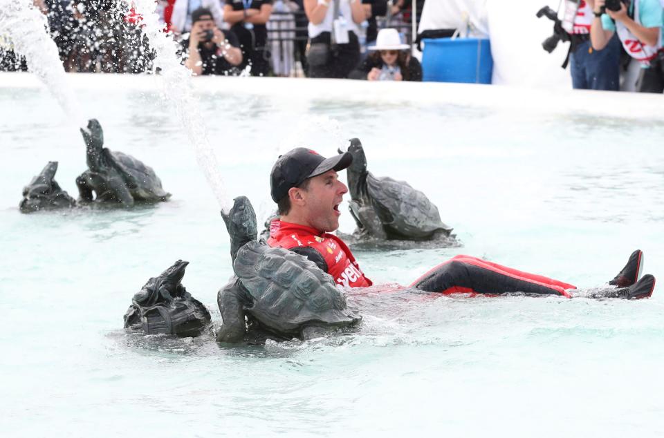 Will Power, driver of the Verizon Team Penske Chevrolet, jumps into the James Scott Memorial fountain after  the IndyCar series Detroit Grand Prix on Sunday, June 5, 2022, on Belle Isle in Detroit.