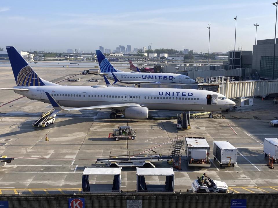 United Airlines planes parked at Terminal 1 gates in anticipation of operations resuming at Fort Lauderdale-Hollywood International Airport on Friday, April 14, 2023. The airport was closed late Wednesday after torrential rains caused major flooding across South Florida. (Mike Stocker/South Florida Sun-Sentinel via AP)