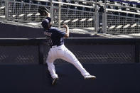 Tampa Bay Rays right fielder Manuel Margot reaches over a right field wall after catching a foul ball by Houston Astros center fielder George Springer during the second inning in Game 2 of a baseball American League Championship Series, Monday, Oct. 12, 2020, in San Diego. (AP Photo/Jae C. Hong)