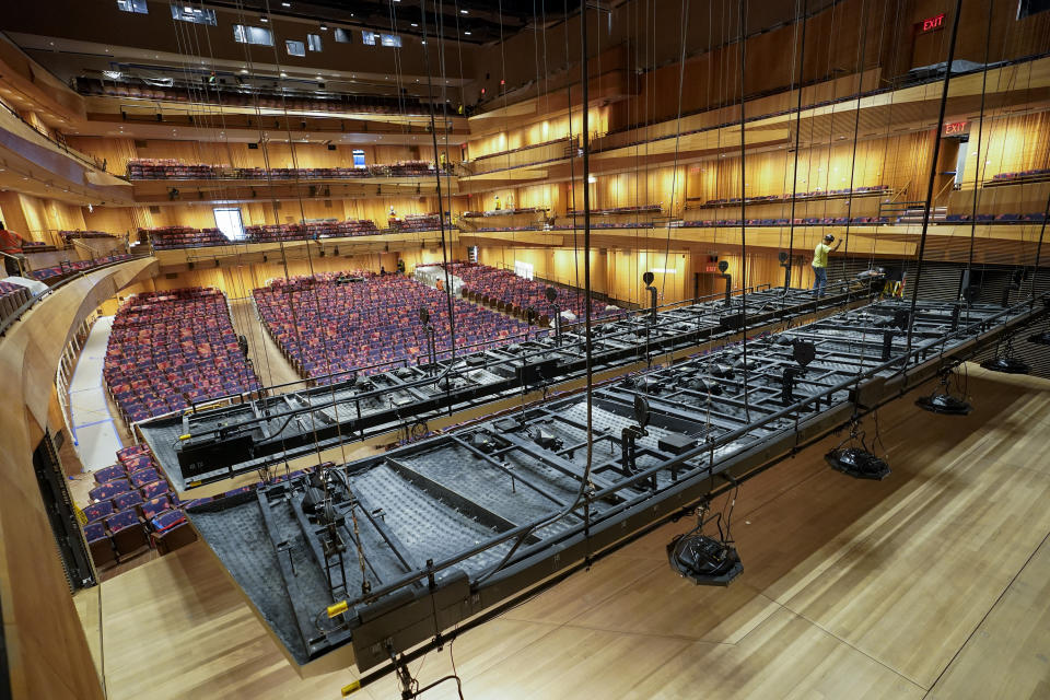 Construction workers install acoustic reflectors in the newly renovated Wsu Tsai Theater at David Geffen Hall is seen, Thursday, Aug. 25, 2022, at the Lincoln Center for the Performing Arts in New York. Geffen Hall opens Oct. 8 following a $550 million renovation with the orchestra’s first concert there since March 10, 2020, the final performance before the pandemic shutdown. (AP Photo/Mary Altaffer)