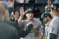 Oakland Athletics pitcher JP Sears (38) is greeted in the dugout after being pulled from a baseball game against the Texas Rangers during the seventh inning Thursday, April 11, 2024, in Arlington, Texas. (AP Photo/Michael Ainsworth)