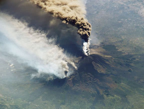 Plumes of smoke and ash erupt from Mount Etna on Oct. 30, 2002.