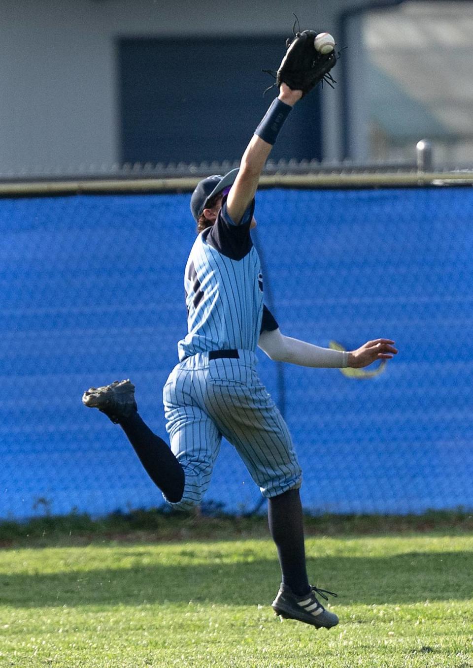 Downey outfielder Isaac Doornewaard tracks down a fly ball for the out during the Central California Athletic League game with Turlock at Downey High School in Modesto, Calif., Friday, April 12, 2024.