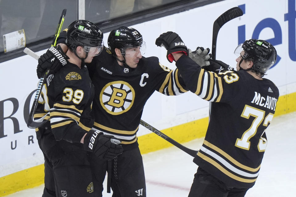 Boston Bruins center Morgan Geekie (39) celebrates with left wing Brad Marchand (63) and defenseman Charlie McAvoy (73) after scoring in the second period of an NHL hockey game against the Vegas Golden Knights, Thursday, Feb. 29, 2024, in Boston. (AP Photo/Steven Senne)