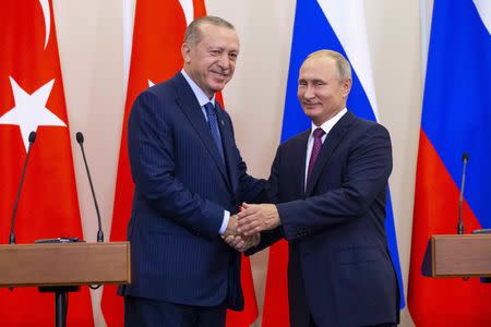 Russian President Vladimir Putin (R) and his Turkish counterpart Tayyip Erdogan shake hands during a news conference following their talks in Sochi, Russia September 17, 2018. Alexander Zemlianichenko/Pool via REUTERS