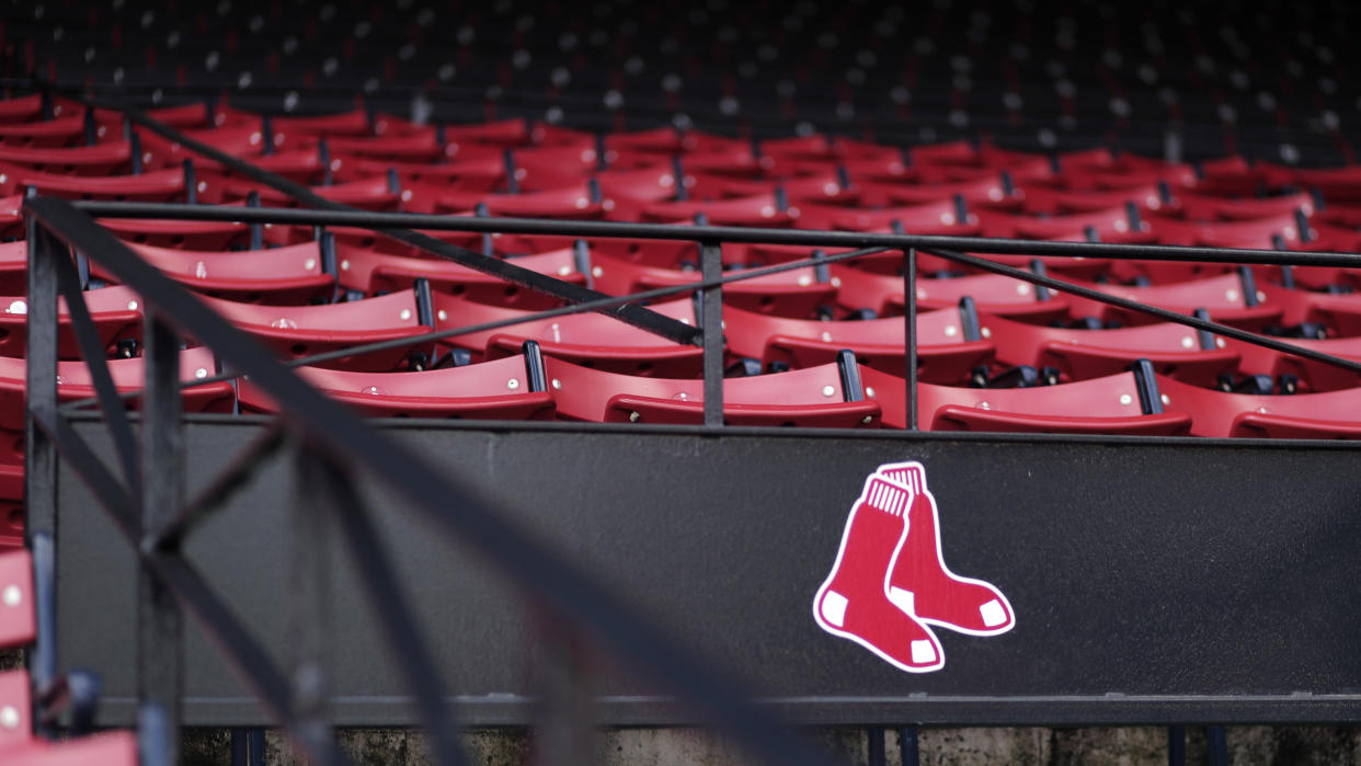 Red Sox logo with empty seats in the background.