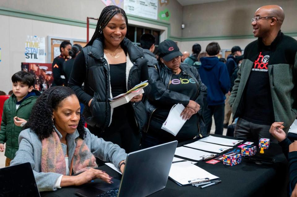 Agnes Jite-Ogbuehi, left, signs up for information from the Black Youth Leadership Project during an open house at Monterey Trail High School in Elk Grove on Thursday, Jan. 11, 2023.