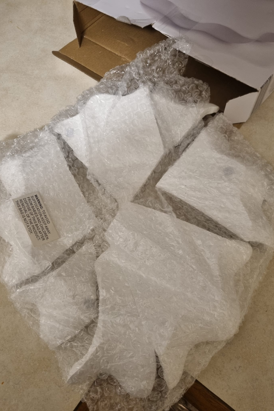 A broken Kmart wave bowl in bubble wrap