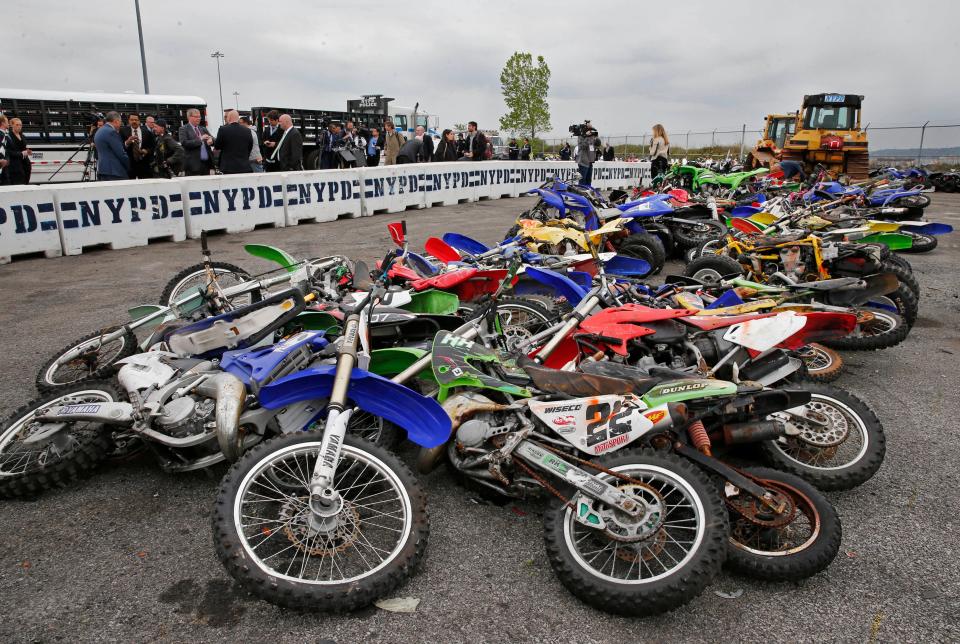 A pile of 70 confiscated motorcycles and all-terrain vehicles are on display after the New York Police Department crushed some of the 700 confiscated vehicles at the Erie Basin tow pound in Brooklyn's Red Hook neighborhood on May 17, 2016, in New York. New York Police Department Commissioner William Bratton, who attended the event, said the department has been cracking down on unlicensed drivers who operate ATVs, minibikes and motorcycles without helmets. So far this year, more than 679 bikes have been confiscated and dozens of drivers arrested on such charges as reckless endangerment.