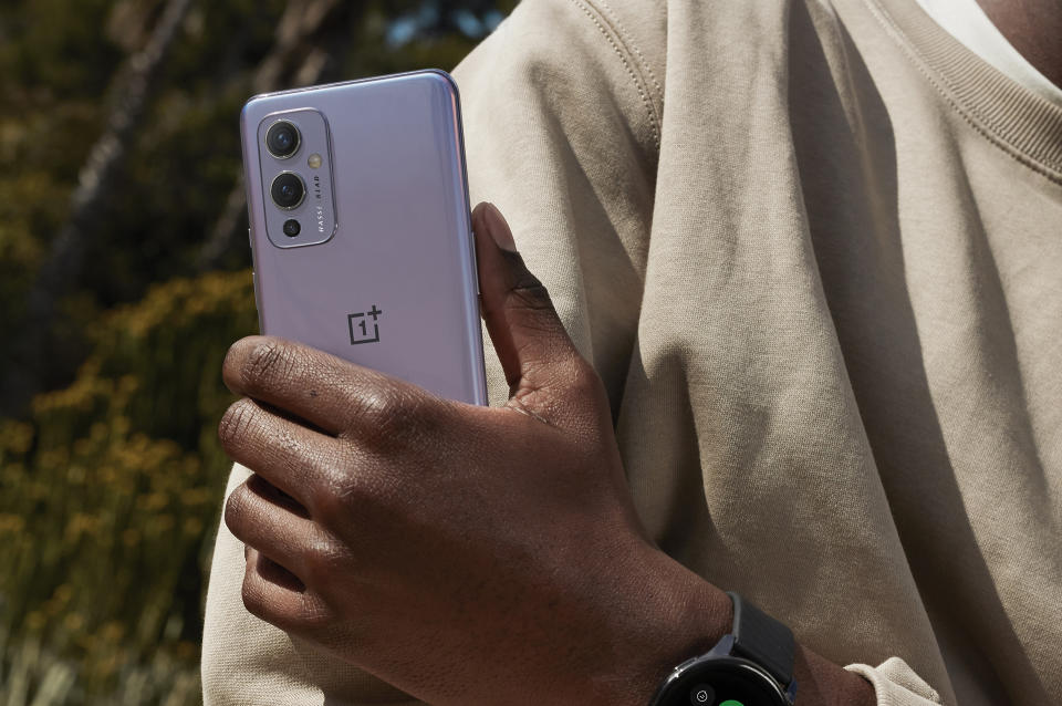 OnePlus 9 smartphone held in hand.