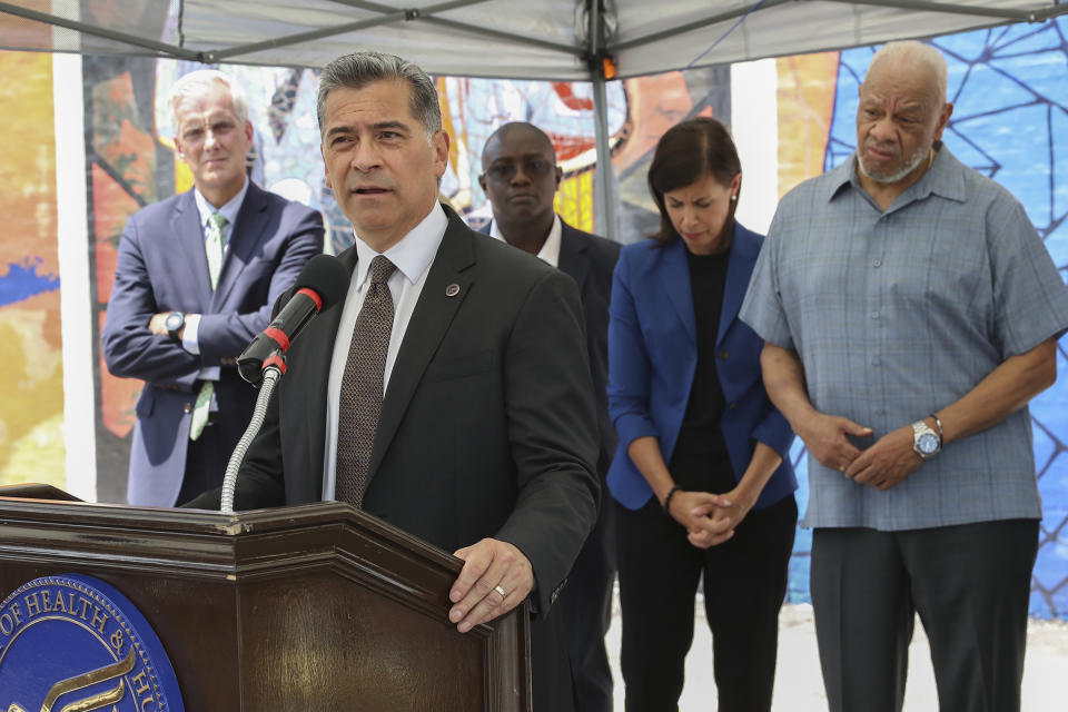 FILE - Xavier Becerra, Secretary of the Department of Health and Human Services, speaks at the podium during a press conference on the kickoff of 988, a new national mental health hotline, in West Philadelphia, July 15, 2022. The press conference took place in front of the Contemplation, Clarity and Resilience mural by artist Eric Okdeh, which is a mural that represents, among many other things, the process of overcoming hardships. (Heather Khalifa/The Philadelphia Inquirer via AP, File)