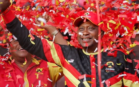 President Uhuru Kenyatta celebrates during a campaign rally in Nairobi - Credit: EPA