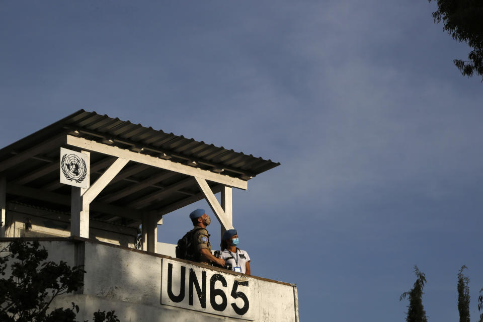 U.N Peacekeepers stand on a guard post in divided capital Nicosia, Cyprus, Saturday, April 24, 2021. United Nations Chief Antonio Guterres will host an informal gathering of the rival Greek Cypriot and Turkish Cypriot leaders as well as the foreign ministers of ethnically split Cyprus' ‘guarantors’ - Greece, Turkey and former colonial ruler Britain in Geneva - in hopes of getting the two sides to embark on a fresh round of formal reunification talks. (AP Photo/Petros Karadjias)