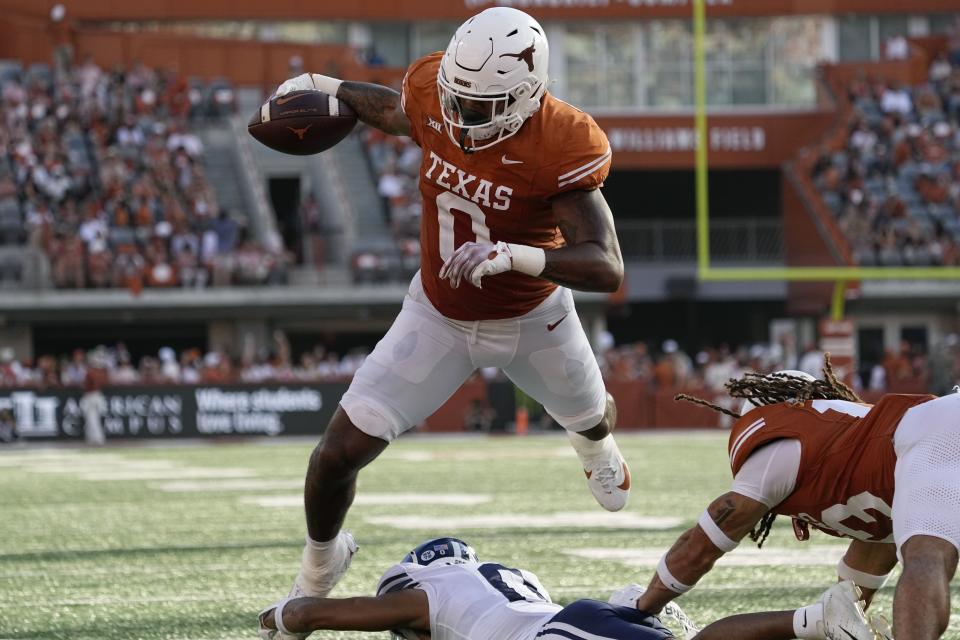Texas tight end Ja’Tavion Sanders (0) is tripped up just short of the goal line by BYU cornerback Jakob Robinson, bottom, during the second half of an NCAA college football game in Austin, Texas, Saturday, Oct. 28, 2023. | Eric Gay, Associated Press