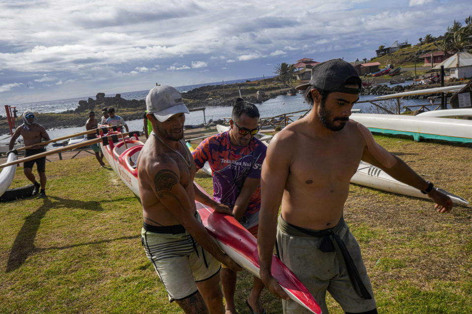 Rapanuis crew members carry their canoe during a training session for the Hoki Mai challenge, a voyage — covering almost 500 kilometers, or about 300 miles across a stretch of the Pacific Ocean, in Rapa Nui, a territory that is part of Chile and is better known as Easter Island, Thursday, Nov. 24, 2022. The athletes have been trainingsixdays a week since mid-September, preparing for a voyage that will take them from Rapa Nui to Motu Motiro Hiva. (AP Photo/Esteban Felix)