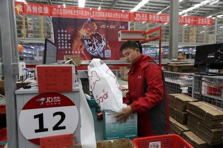 An employee works at a JD.com logistic centre in Langfang, Hebei province, November 10, 2015. REUTERS/Jason Lee