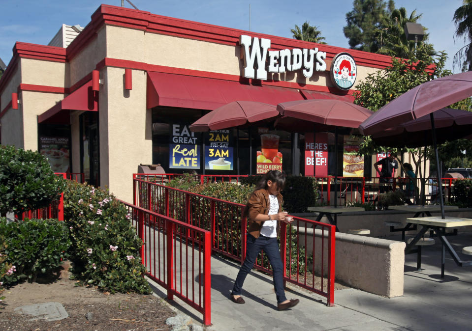 In this Jan. 29, 2012 photo, a customer leaves a Wendy's restaurant in Los Angeles. Wendy’s Co.’s adjusted net income fell to $4.3 million in the fourth quarter, a 29 percent drop from $6.1 million a year ago. (AP Photo/Reed Saxon)