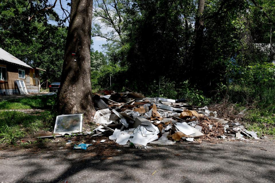 Dumping of trash near a tree on Bentler Street in the Brightmoor area of Detroit on Wednesday, June 15, 2022. 