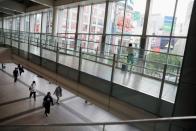 People wearing protective face masks walk at Shibuya station as the spread of the coronavirus disease (COVID-19) continues, in Tokyo