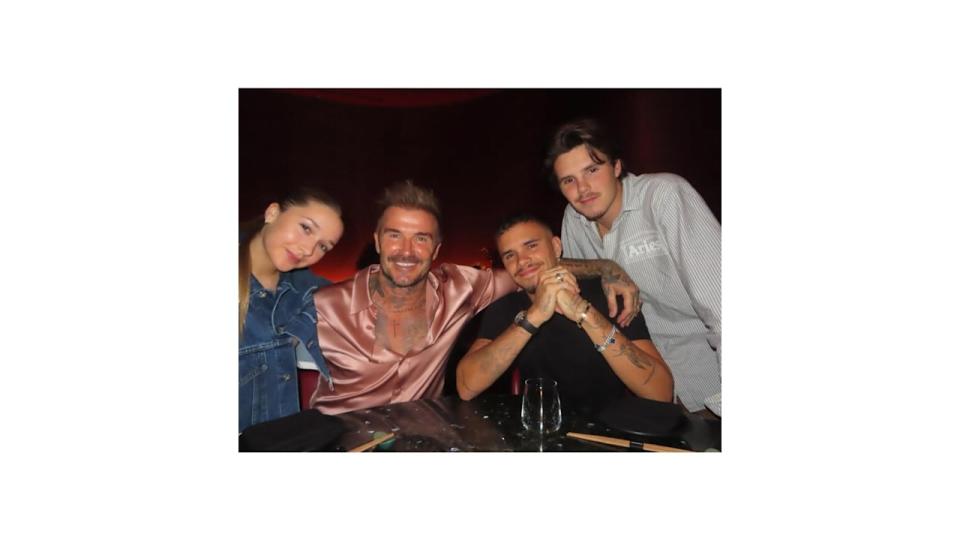 beckham family posing at dinner table