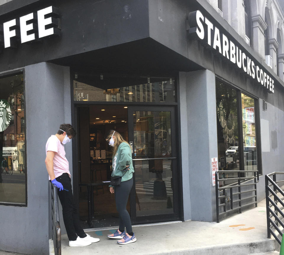 Photo by: STRF/STAR MAX/IPx 2020 5/15/20 2 patrons stand outside a Starbucks in Manhattan during the coronavirus pandemic in NYC.