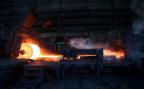 A steel coil is unrolled on the line at the Novolipetsk Steel PAO steel mill in Farrell, Pennsylvania, U.S., March 9, 2018. REUTERS/Aaron Josefczyk