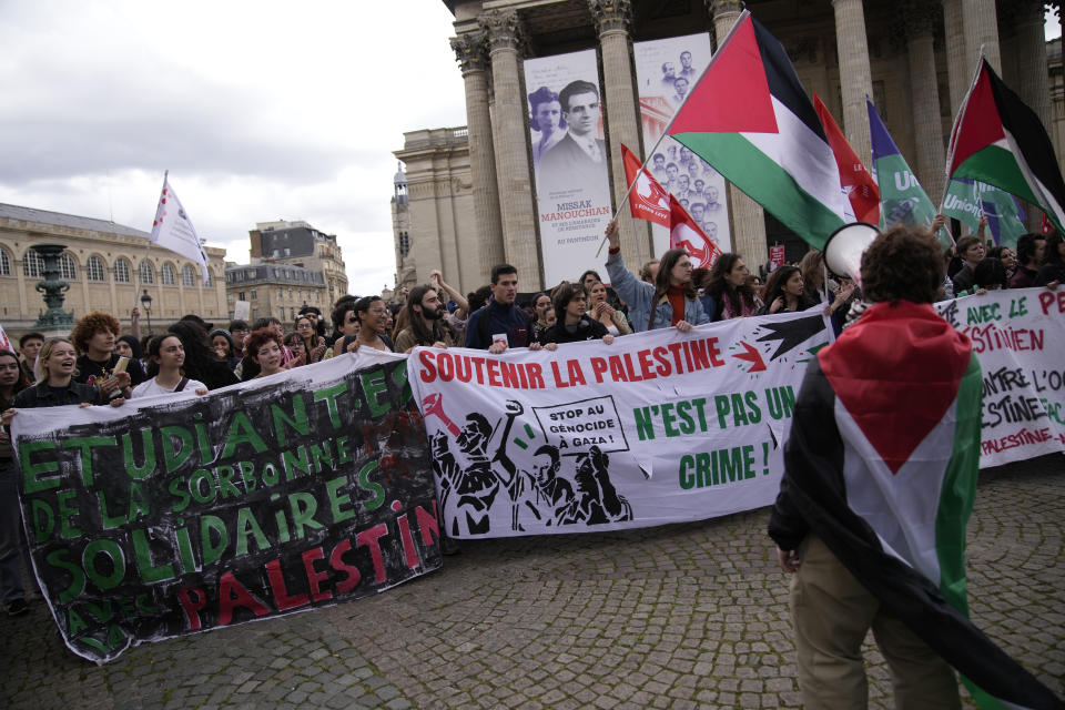 Students gather at the Pantheon monument Friday, May 3, 2024 in Paris. Students waved Palestinian flags and chanted slogans in support of residents of Gaza, as Israel continues its offensive following the deadly Oct. 7 Hamas-led attack that triggered the Israeli-Hamas war. (AP Photo/Christophe Ena)