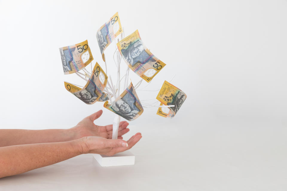 Pictured: $50 notes growing on small tree suggesting retirement savings. Image: Getty