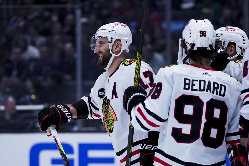 Chicago Blackhawks left wing Nick Foligno, left, smiles after scoring against the Los Angeles Kings during the first period of an NHL hockey game Tuesday, March 19, 2024, in Los Angeles. (AP Photo/Ryan Sun)