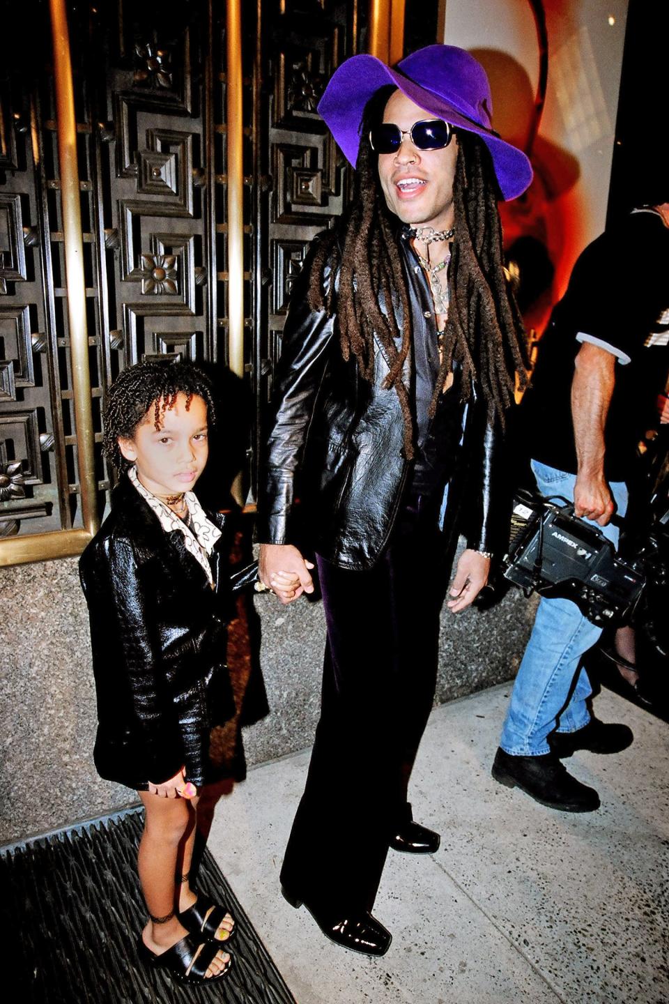 The pair arrive at the 1997 MTV Video Music Awards in N.Y.C. matching in leather outfits. Dad topped his off with a bright purple hat, while Zoë wore strappy sandals.