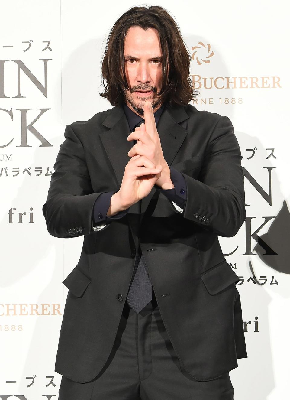 Keanu Reeves gets into character at the Japan premiere of <em>John Wick: Chapter 3 — Parabellum</em> on Tuesday in Tokyo.