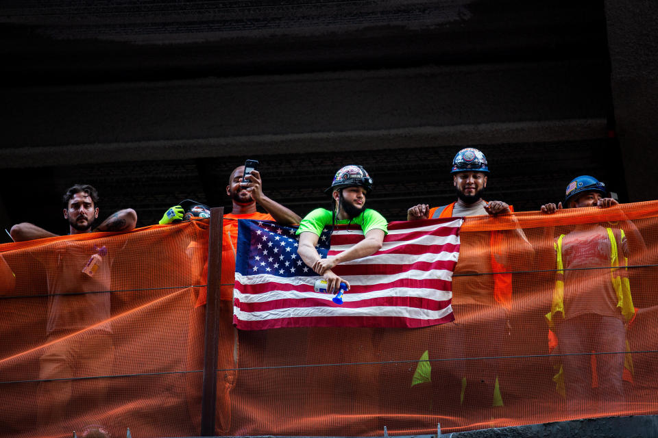 Construction workers watch the parade. (Photo: Demetrius Freeman for HuffPost)